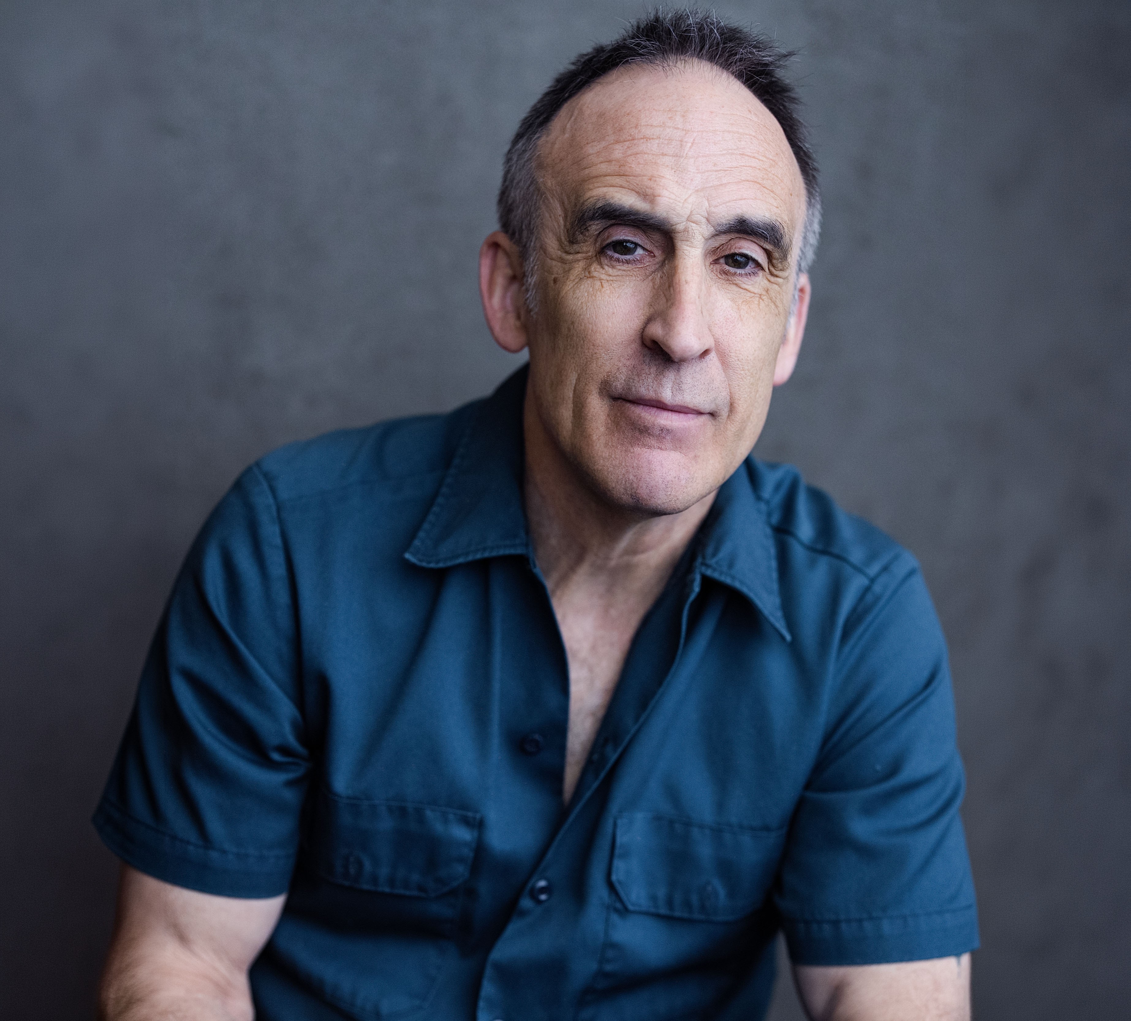 Headshot portrait of actor Victor Verhaeghe looking forward, featured in character for the play production.